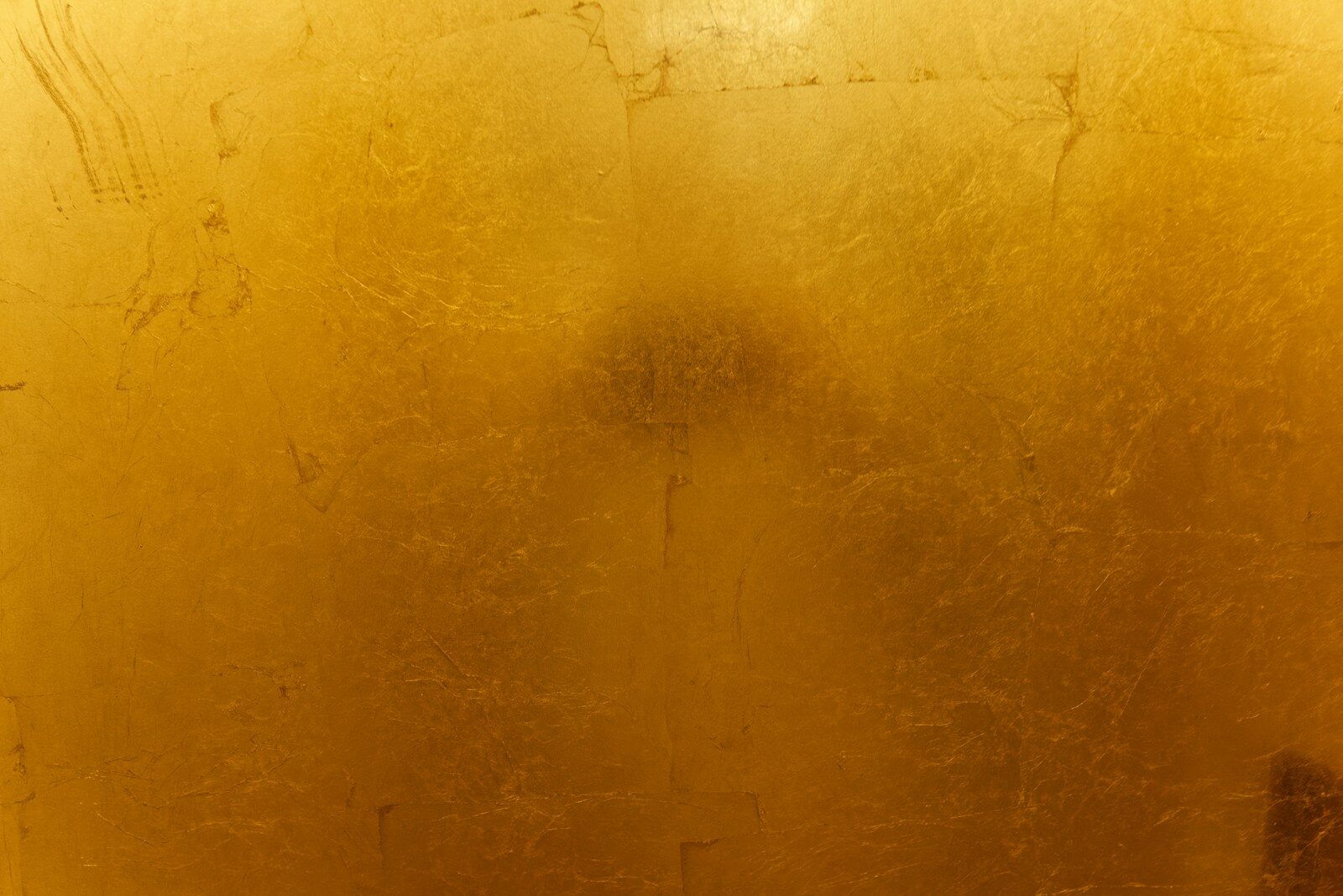 A close up of a toilet with a yellow wall